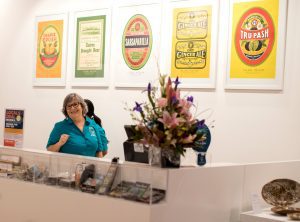 Cairns Museum volunteer at front desk smiling
