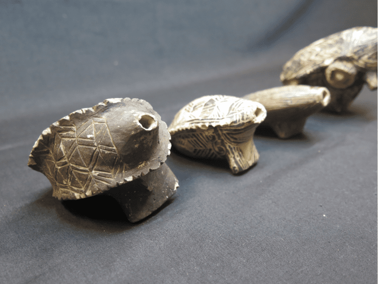 PNG hand carved musical instruments on display in the Han Mak Belong Tumbuna exhibition at Cairns Museum